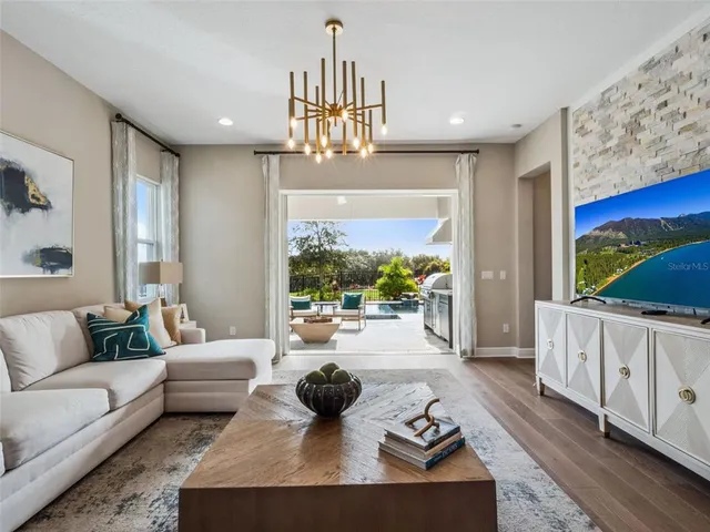 a living room with furniture fireplace and a large window