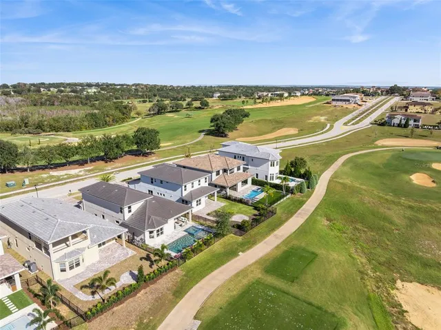 an aerial view of residential houses with outdoor space and city view