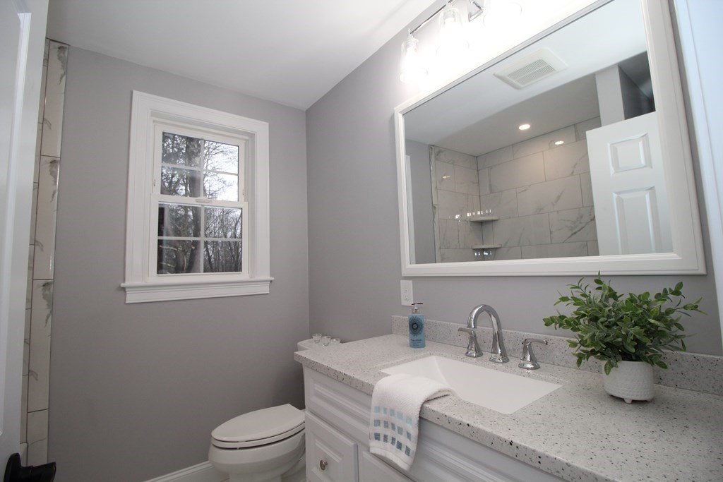 79 Dudley Road Templeton, MA 01468 - Photo 17 of 40 a bathroom with a granite countertop sink mirror and toilet
