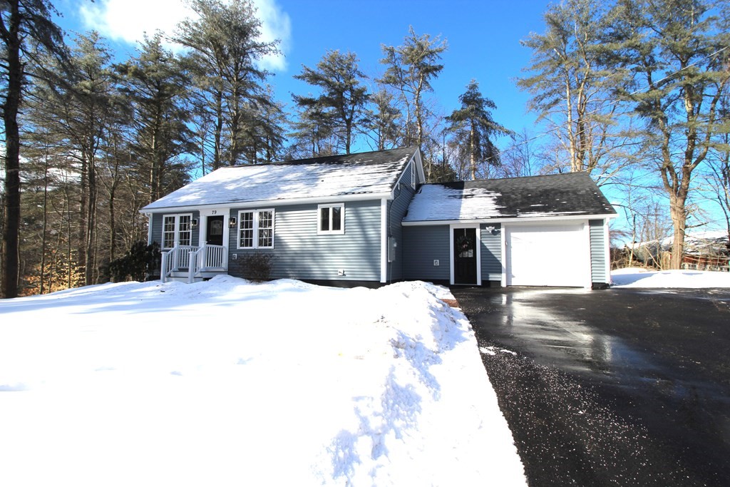 79 Dudley Road Templeton, MA 01468 - Photo 2 of 40 a front view of a house with a yard covered with snow and trees