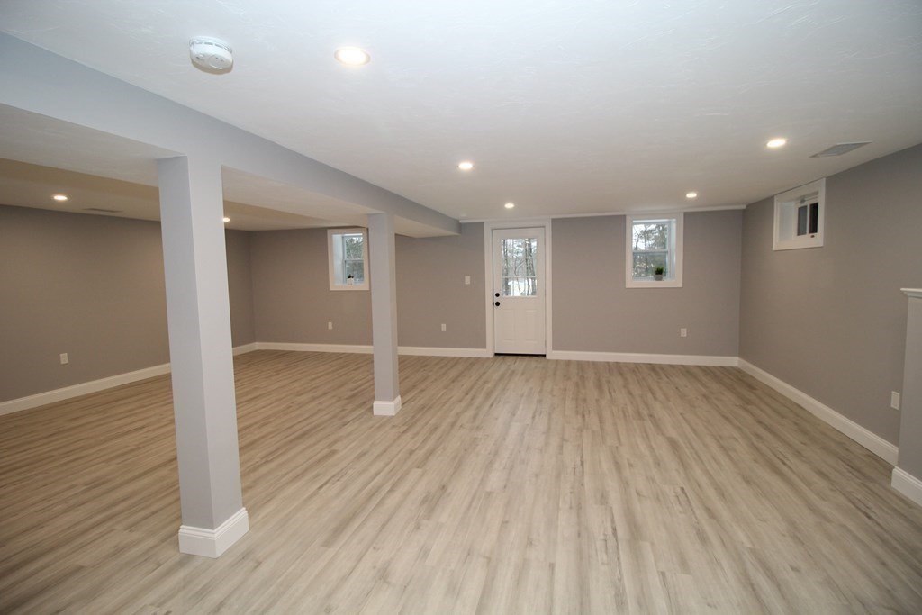 79 Dudley Road Templeton, MA 01468 - Photo 30 of 40 an empty room with wooden floor and windows