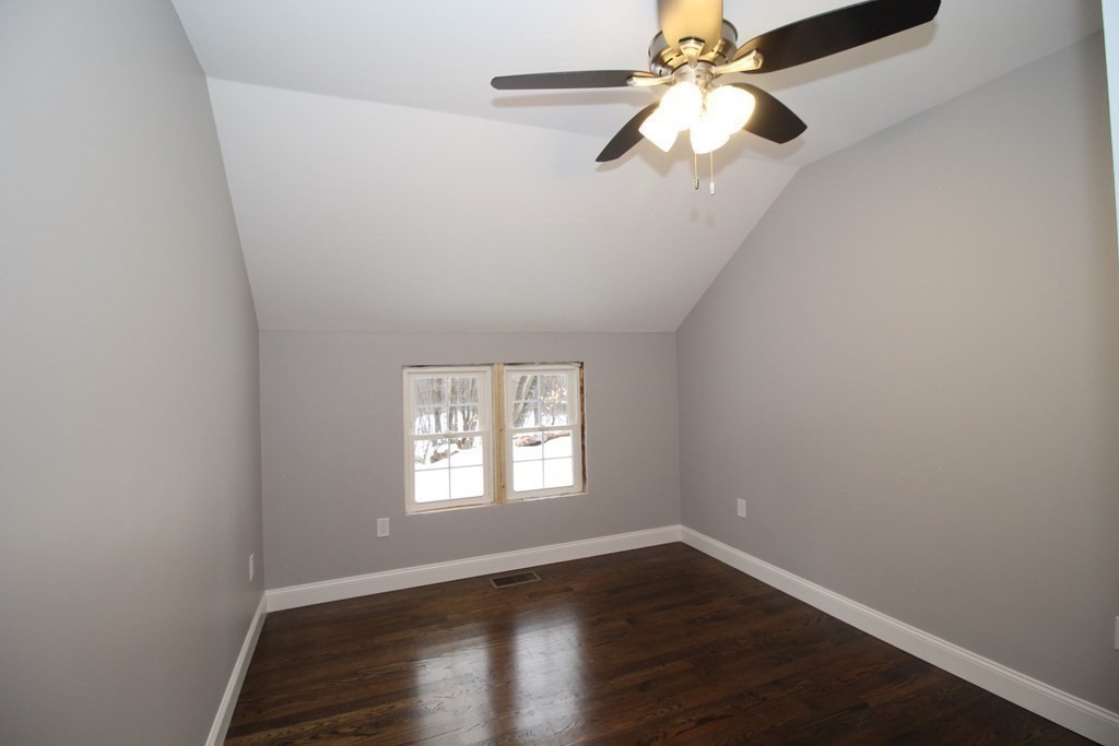79 Dudley Road Templeton, MA 01468 - Photo 32 of 40 an empty room with wooden floor chandelier fan and windows