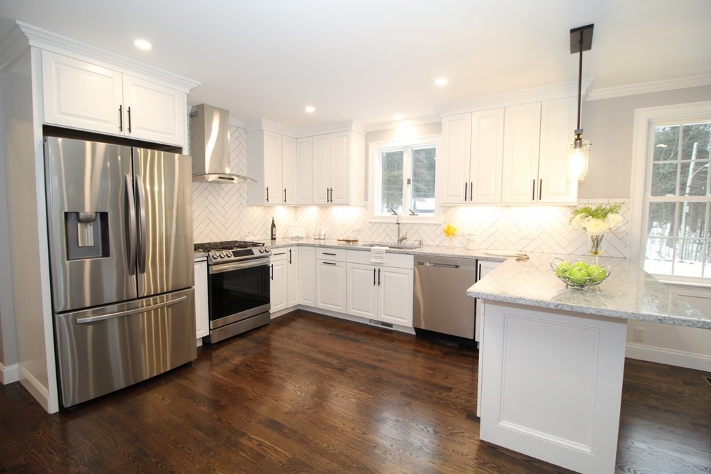 79 Dudley Road Templeton, MA 01468 - Photo 10 of 40 a kitchen with stainless steel appliances and wooden floor