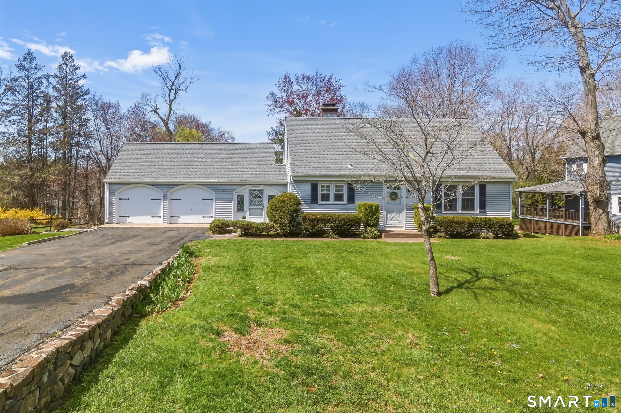a house view with a sitting space and garden