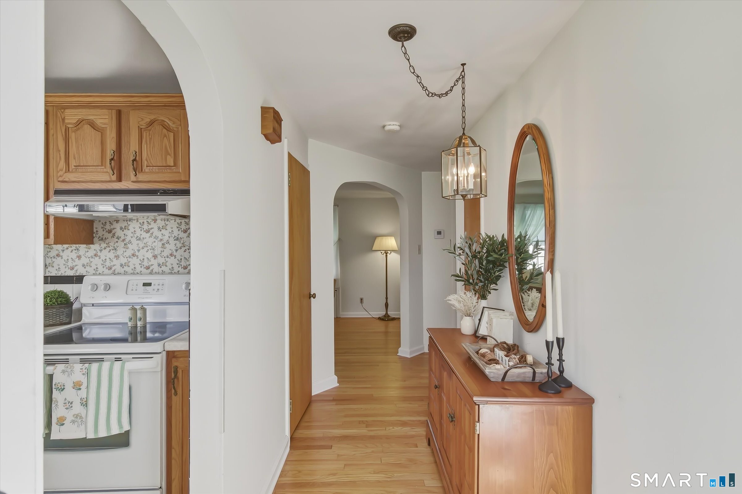 204 Branford Road North Branford, CT 06471 - Photo 10 of 39 a view of a hallway with wooden floor and a living room