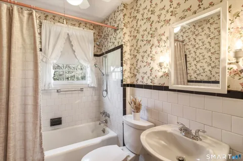 a bathroom with a shower and a sink