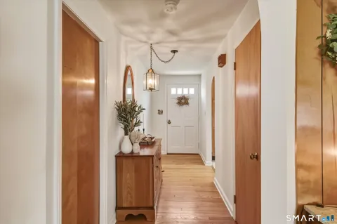 a view of a hallway with wooden floor