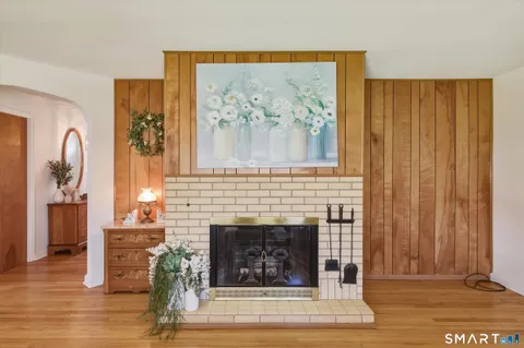 a living room with a fireplace and a wooden floor