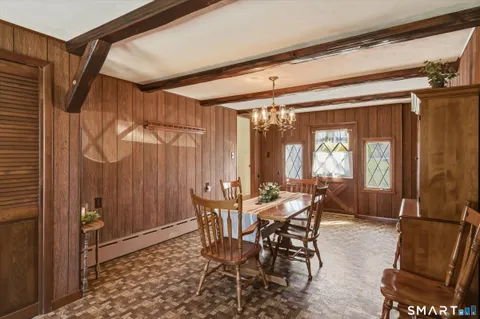 a view of a dining room with furniture and window
