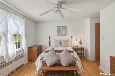 a living room with furniture a window and wooden floor