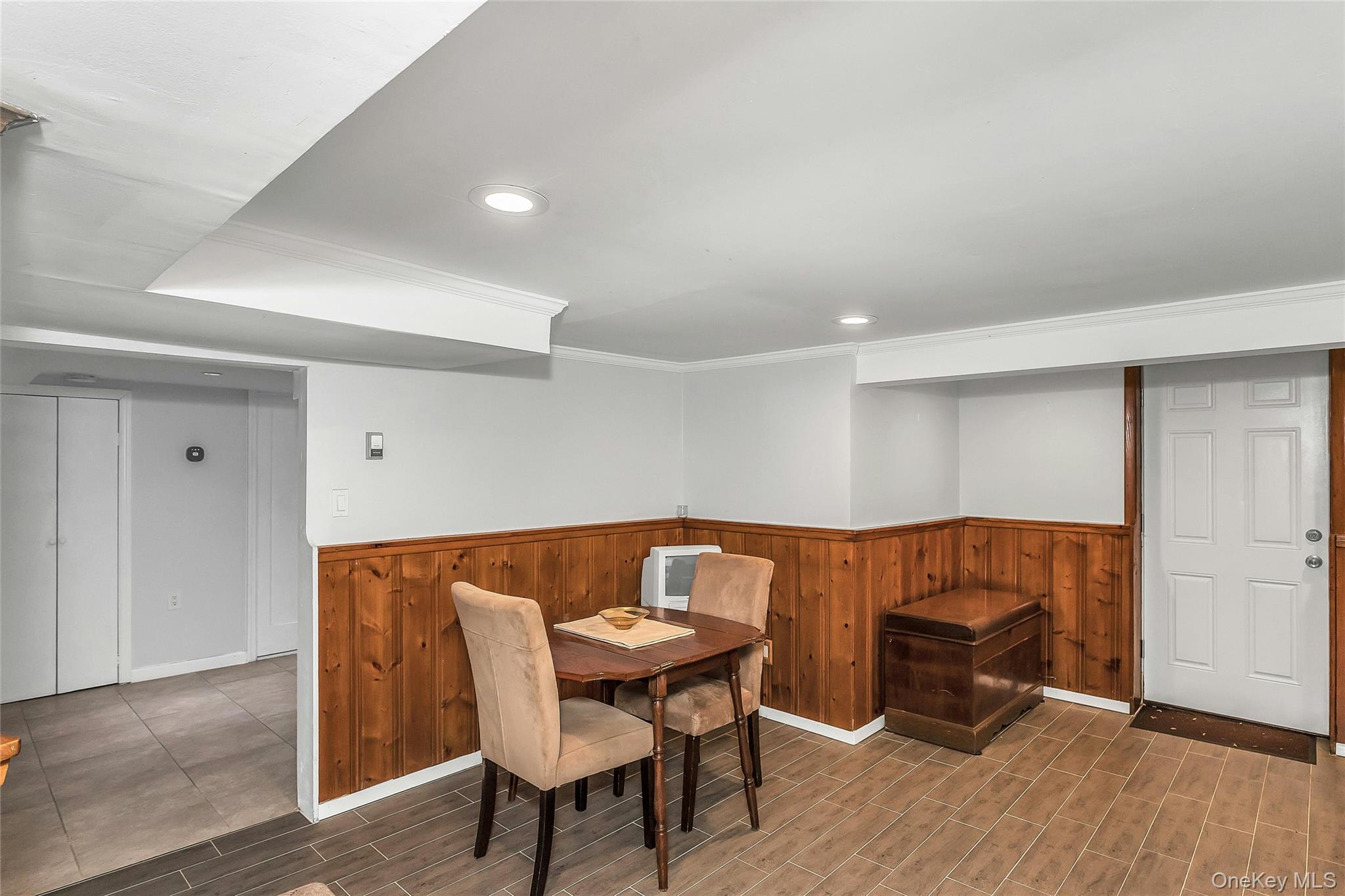 622 Wellelein Road Uniondale, NY 11553 - Photo 12 of 18 Dining room featuring a wainscoted wall, wooden walls, wood finish floors, and recessed lighting