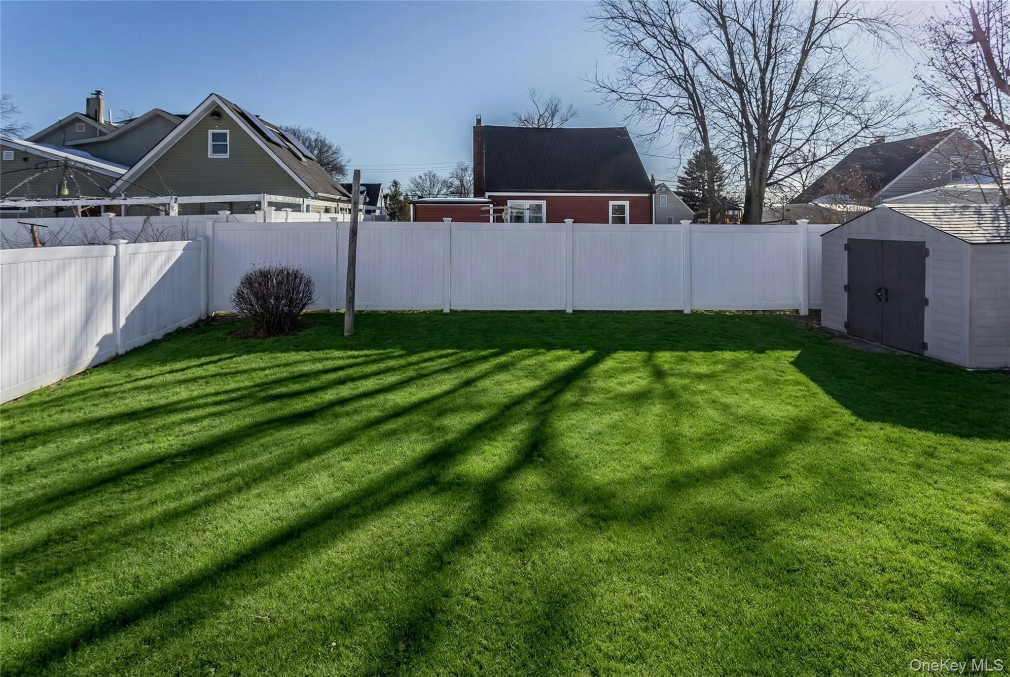 622 Wellelein Road Uniondale, NY 11553 - Photo 17 of 18 Fenced backyard featuring a storage shed