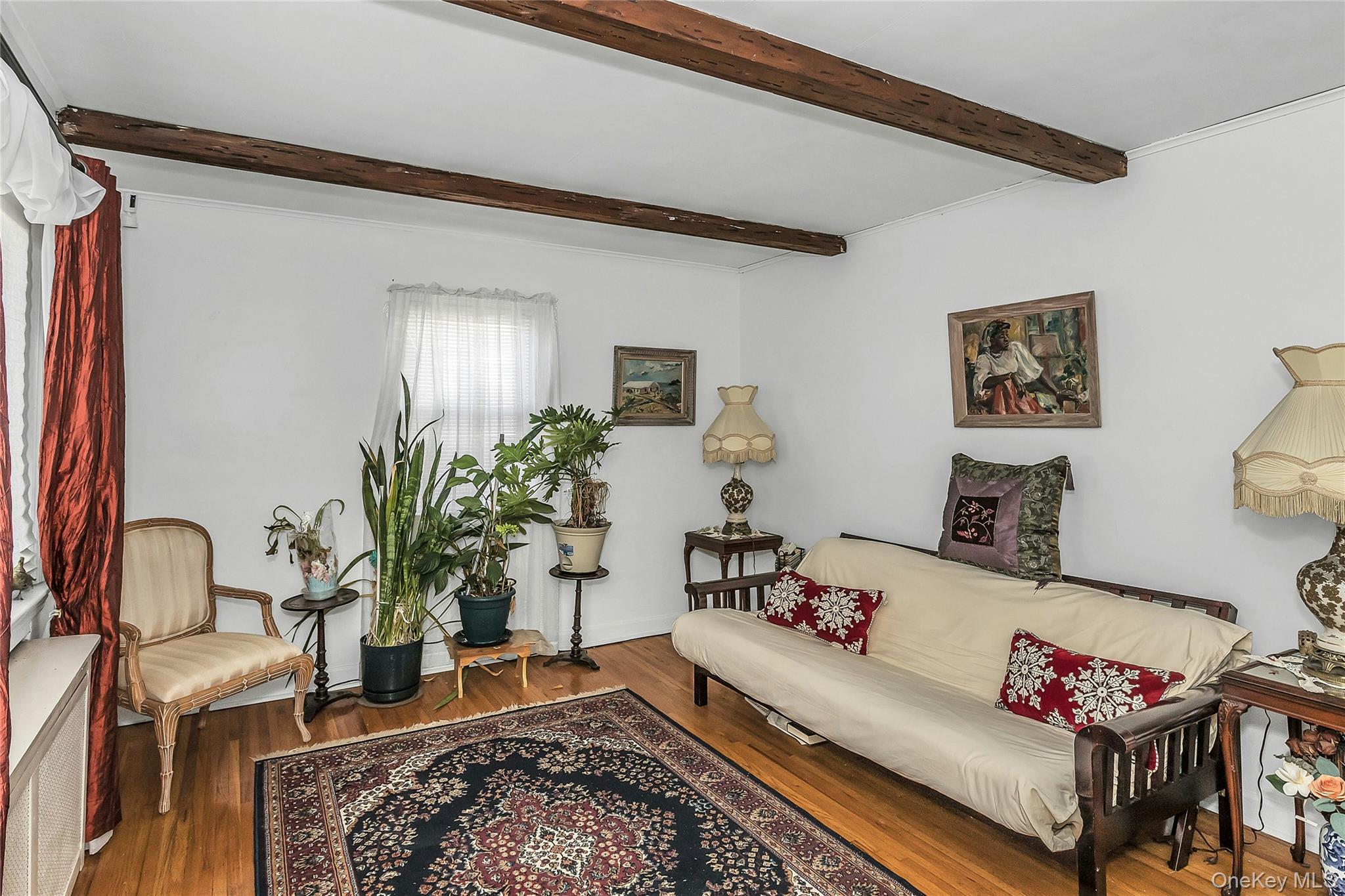 622 Wellelein Road Uniondale, NY 11553 - Photo 3 of 18 Living area featuring wood finished floors and beamed ceiling