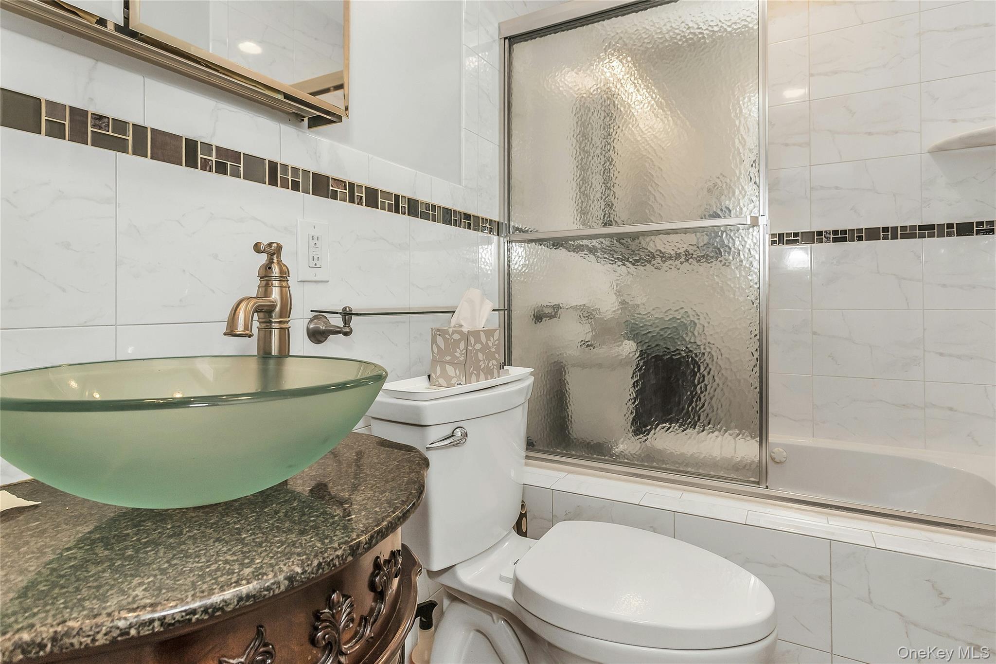 622 Wellelein Road Uniondale, NY 11553 - Photo 9 of 18 Bathroom with tiled shower / bath, vanity, and tile walls