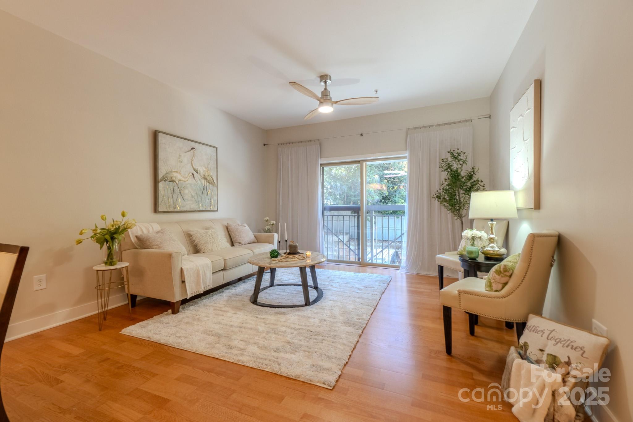 630 Calvert Street, Unit 1110 Charlotte, NC 28208 - Photo 13 of 28 a living room with furniture and wooden floor