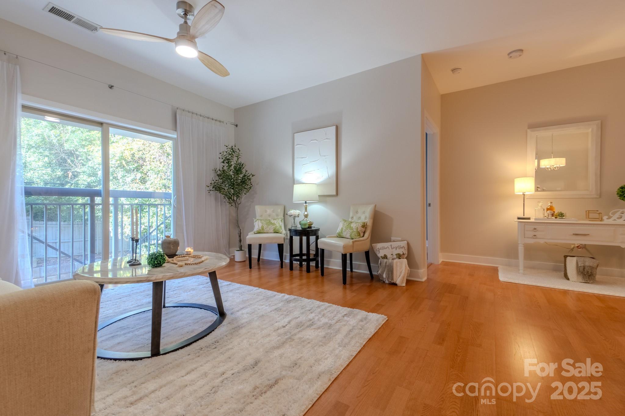 630 Calvert Street, Unit 1110 Charlotte, NC 28208 - Photo 14 of 28 a living room with furniture and a large window