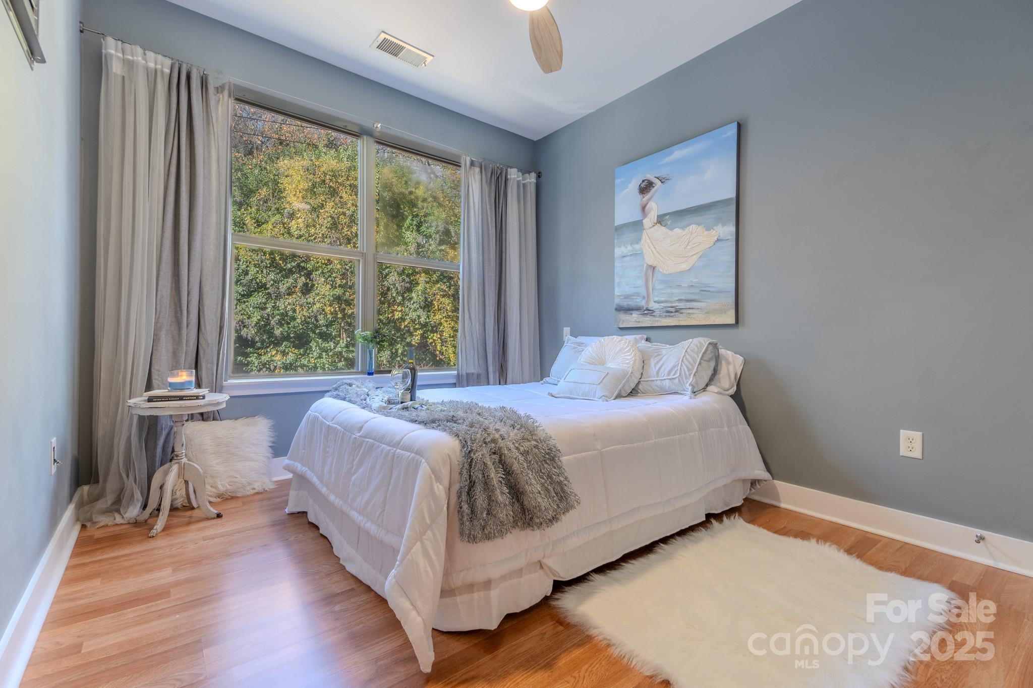 630 Calvert Street, Unit 1110 Charlotte, NC 28208 - Photo 19 of 28 a bedroom with a bed and window