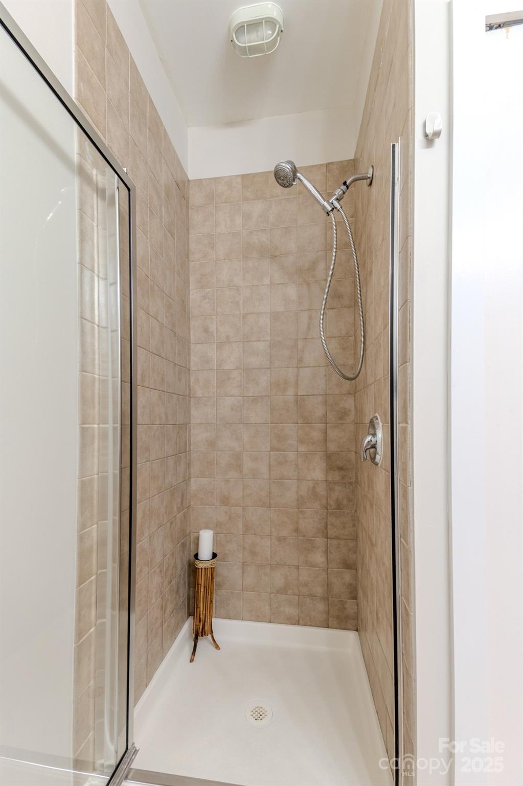 630 Calvert Street, Unit 1110 Charlotte, NC 28208 - Photo 21 of 28 a bathroom with a shower and a sink