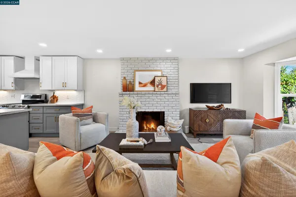 a living room with furniture a fireplace and a flat screen tv
