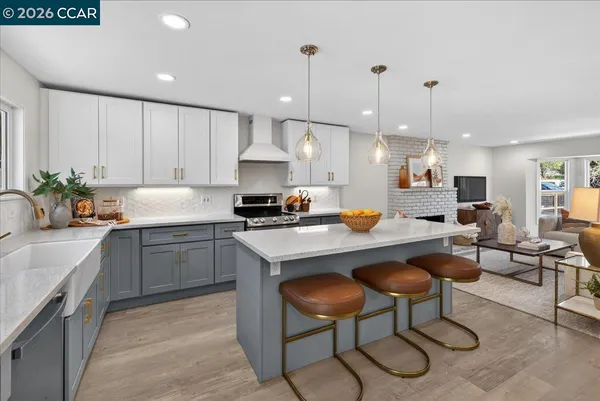 a kitchen with a sink a counter top space appliances and cabinets