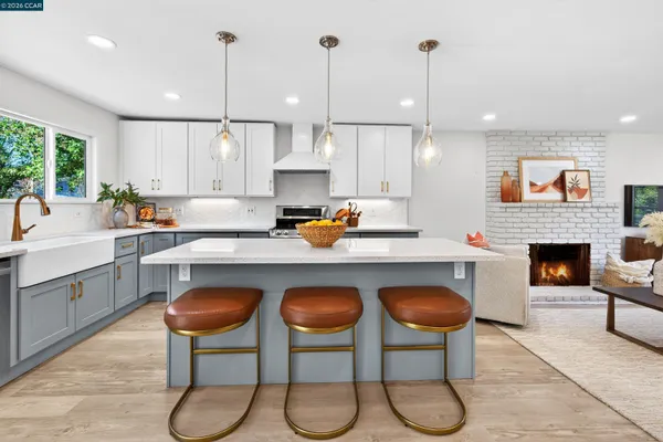 a kitchen with furniture a counter and chairs