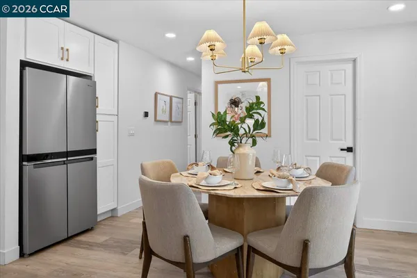a dining room with furniture and wooden floor