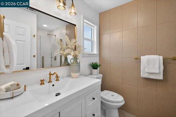 a bathroom with a sink mirror and toilet