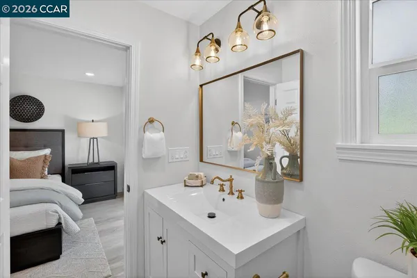 a bathroom with a sink mirror and vanity