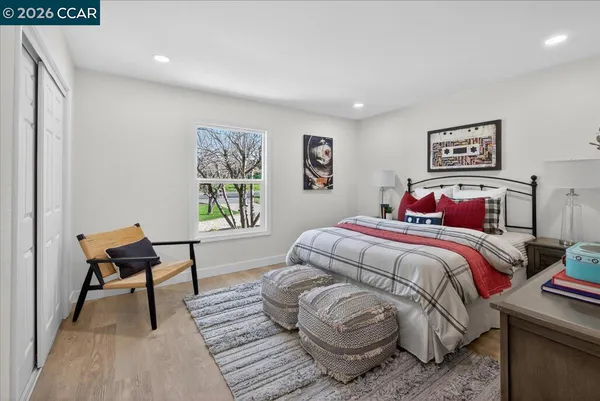 a bedroom with a bed and a chair