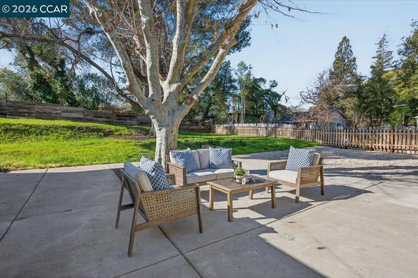 a view of a patio with chairs and a yard