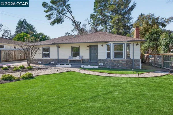 a front view of a house with swimming pool yard and patio