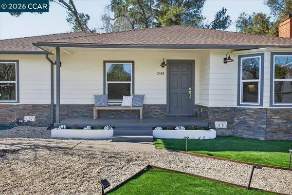 a front view of a house with garden