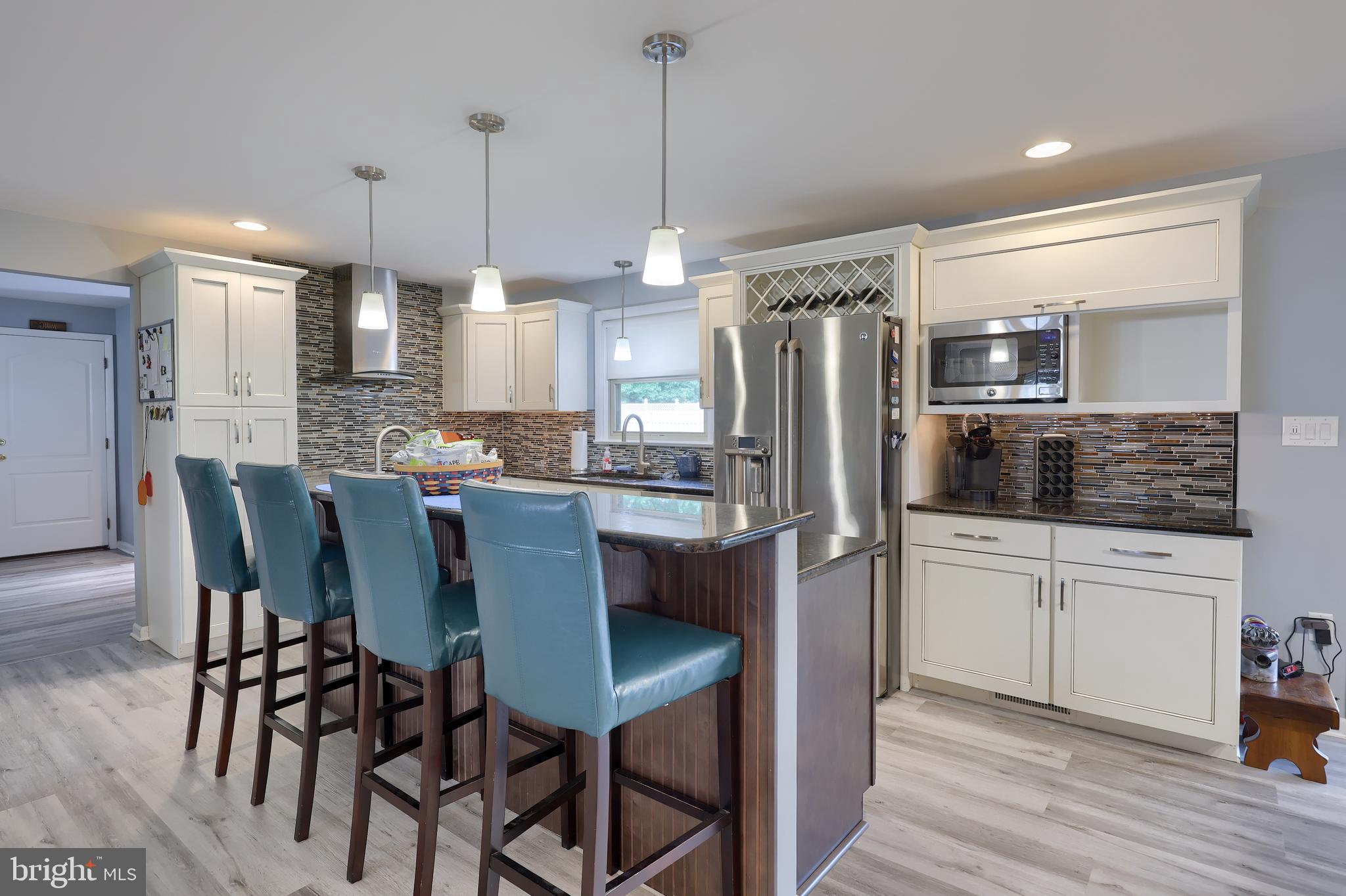 310 West Lexington Road Lititz, PA 17543 - Photo 13 of 58 a kitchen with refrigerator cabinets dining table and chairs