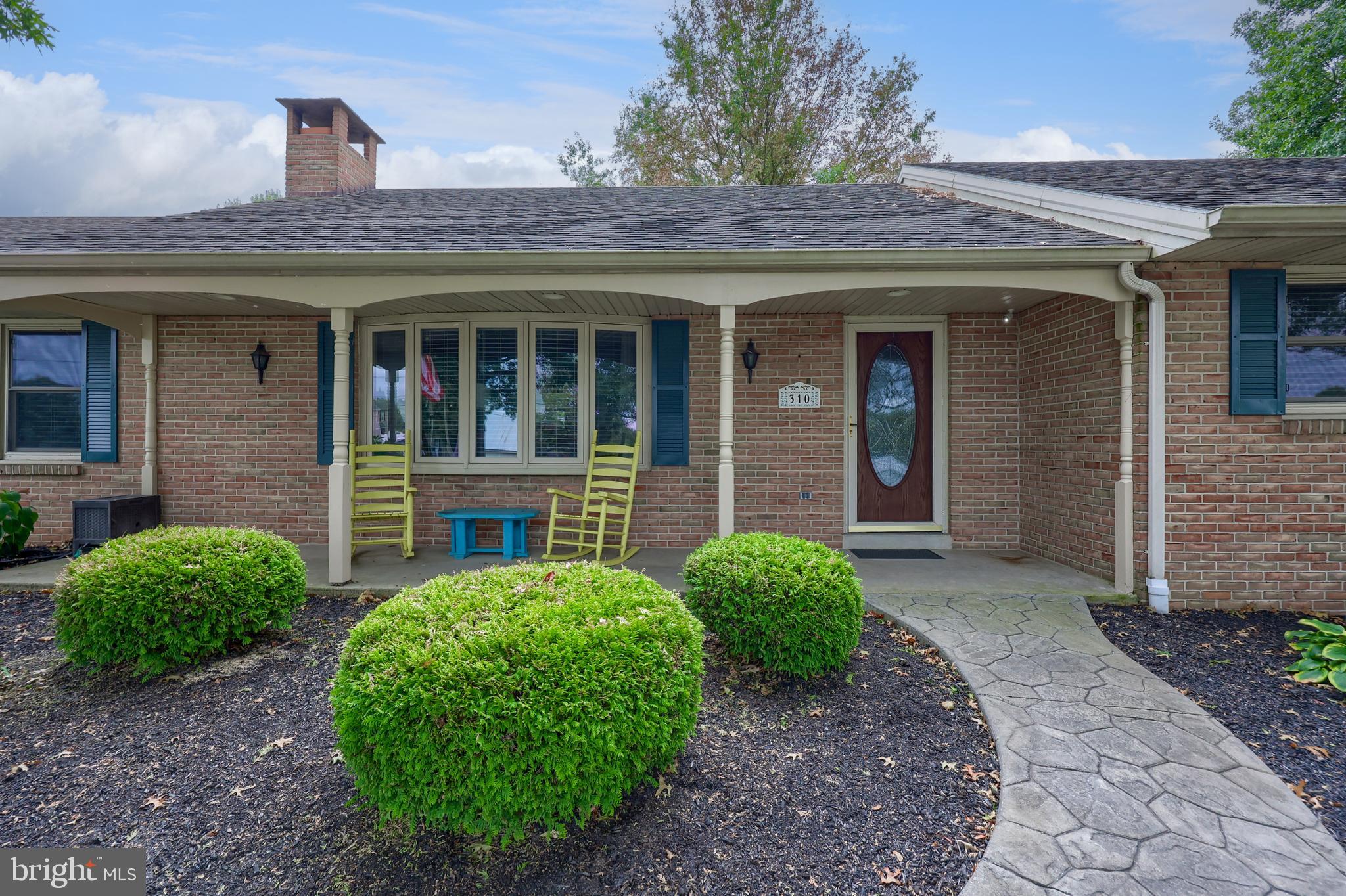 310 West Lexington Road Lititz, PA 17543 - Photo 3 of 58 a view of a house with brick walls plants and large tree