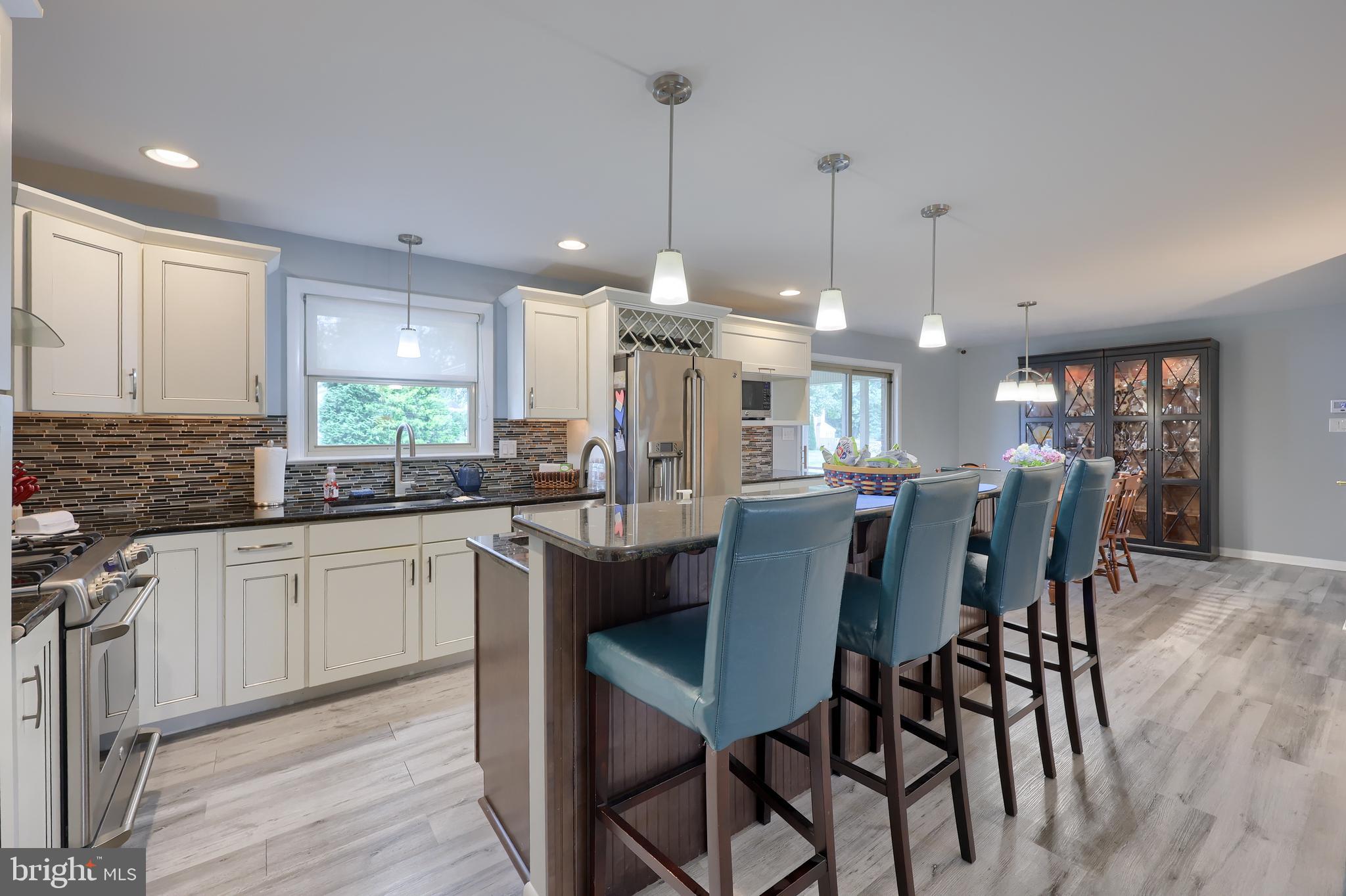 310 West Lexington Road Lititz, PA 17543 - Photo 9 of 58 a kitchen with stainless steel appliances granite countertop a kitchen island a stove a table and chairs