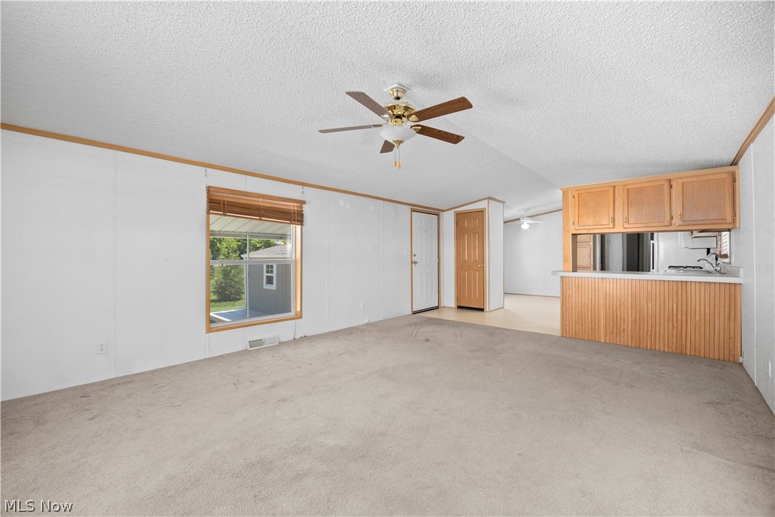 35157 Center Ridge Road, Unit 150 North Ridgeville, OH 44039 - Photo 23 of 33 Open-concept living area with carpet flooring and a ceiling fan