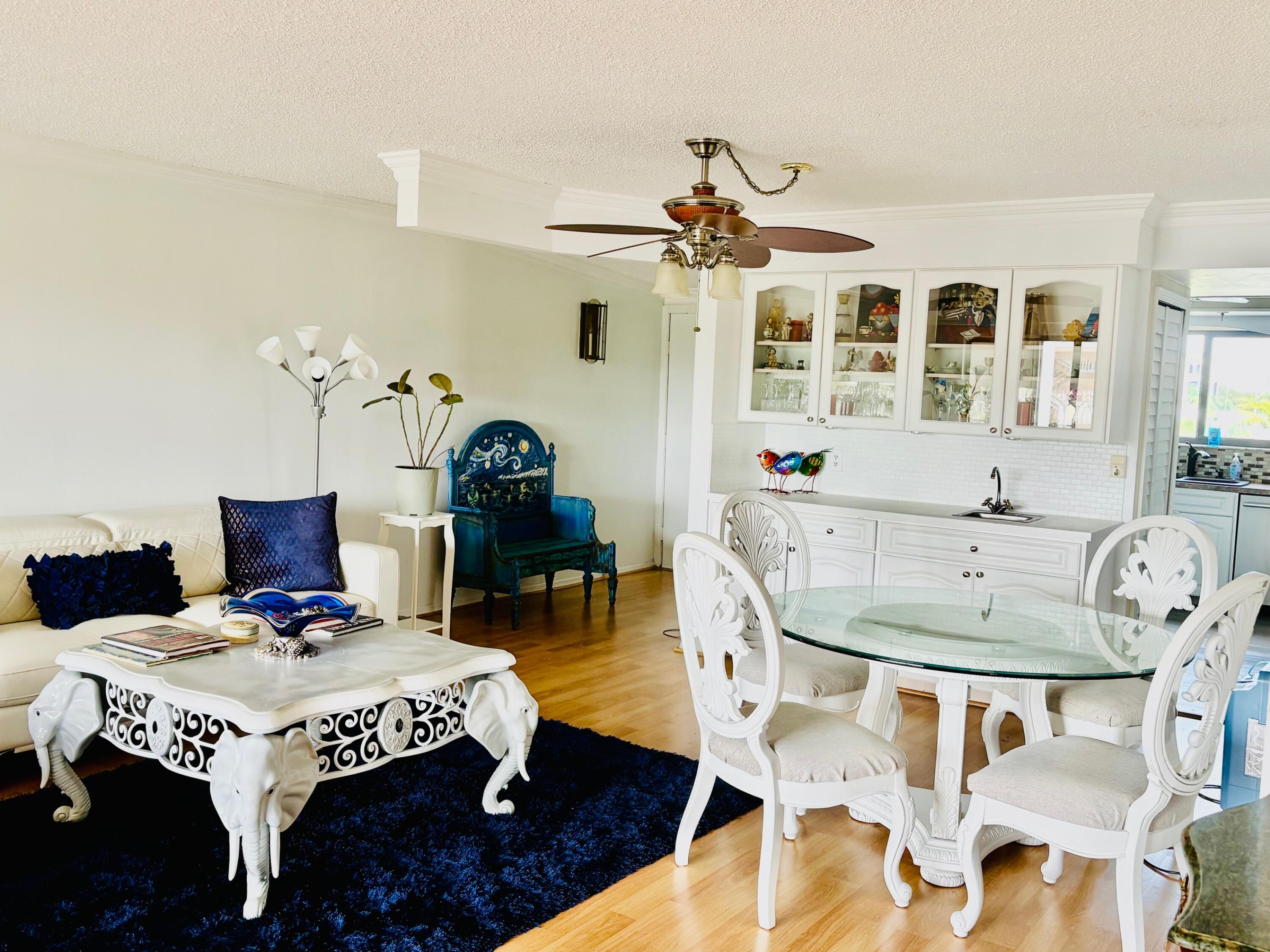 300 Golfview Road, Unit 407 North Palm Beach, FL 33408 - Photo 13 of 56 a living room with furniture a dining table and a chandelier