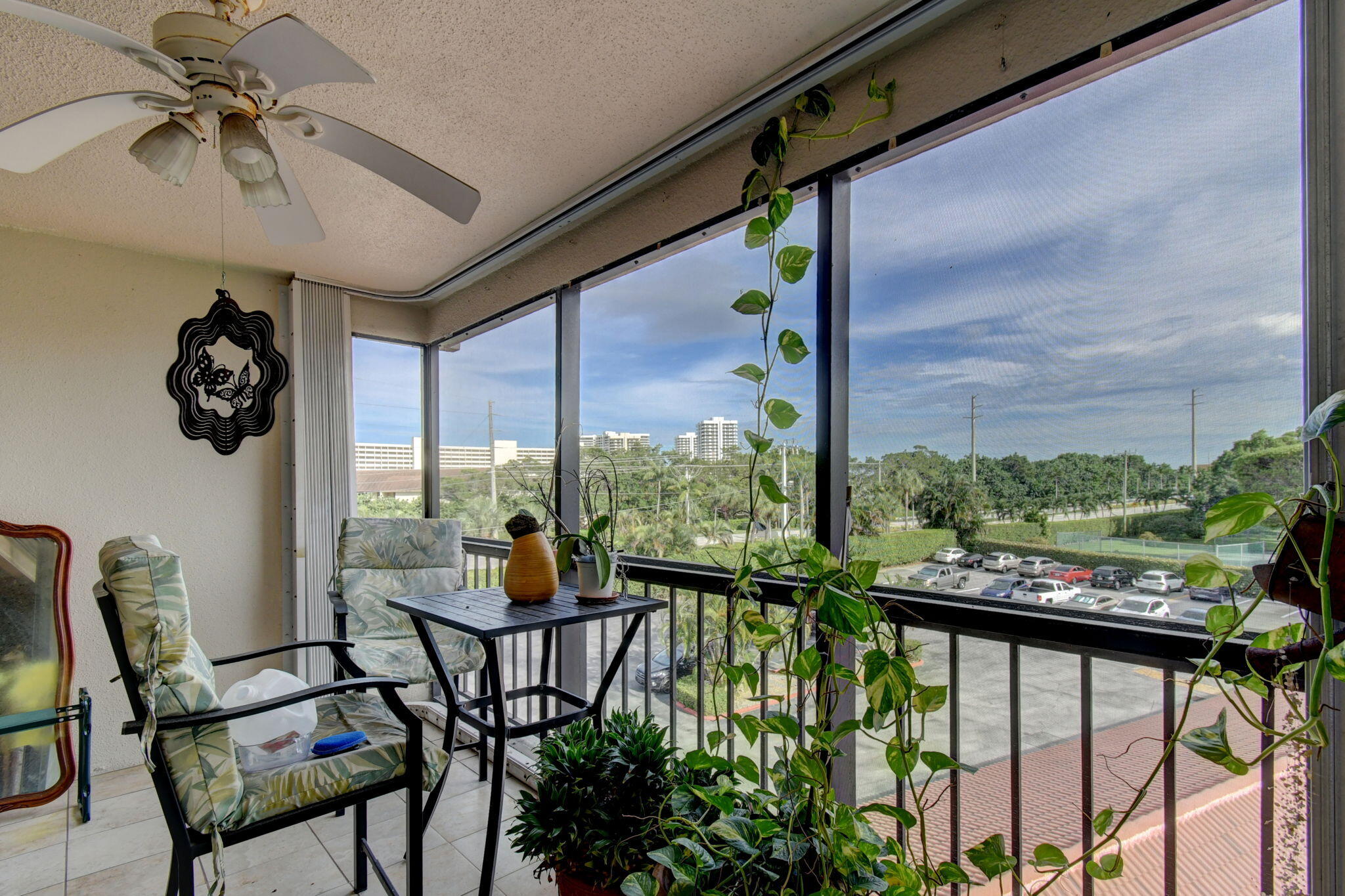 300 Golfview Road, Unit 407 North Palm Beach, FL 33408 - Photo 16 of 56 a view of a porch with furniture and garden