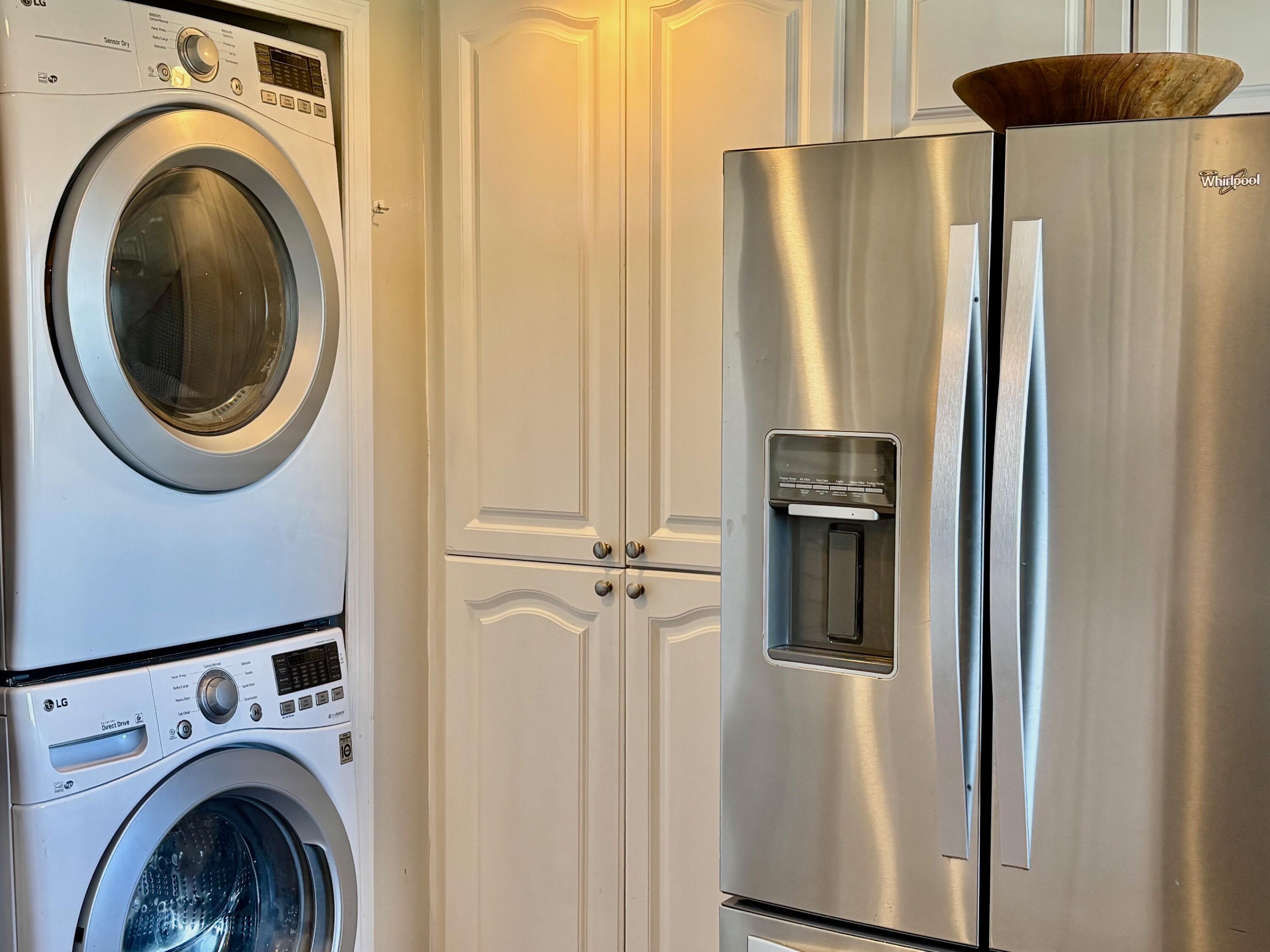 300 Golfview Road, Unit 407 North Palm Beach, FL 33408 - Photo 19 of 56 a view of a hallway with washer and dryer