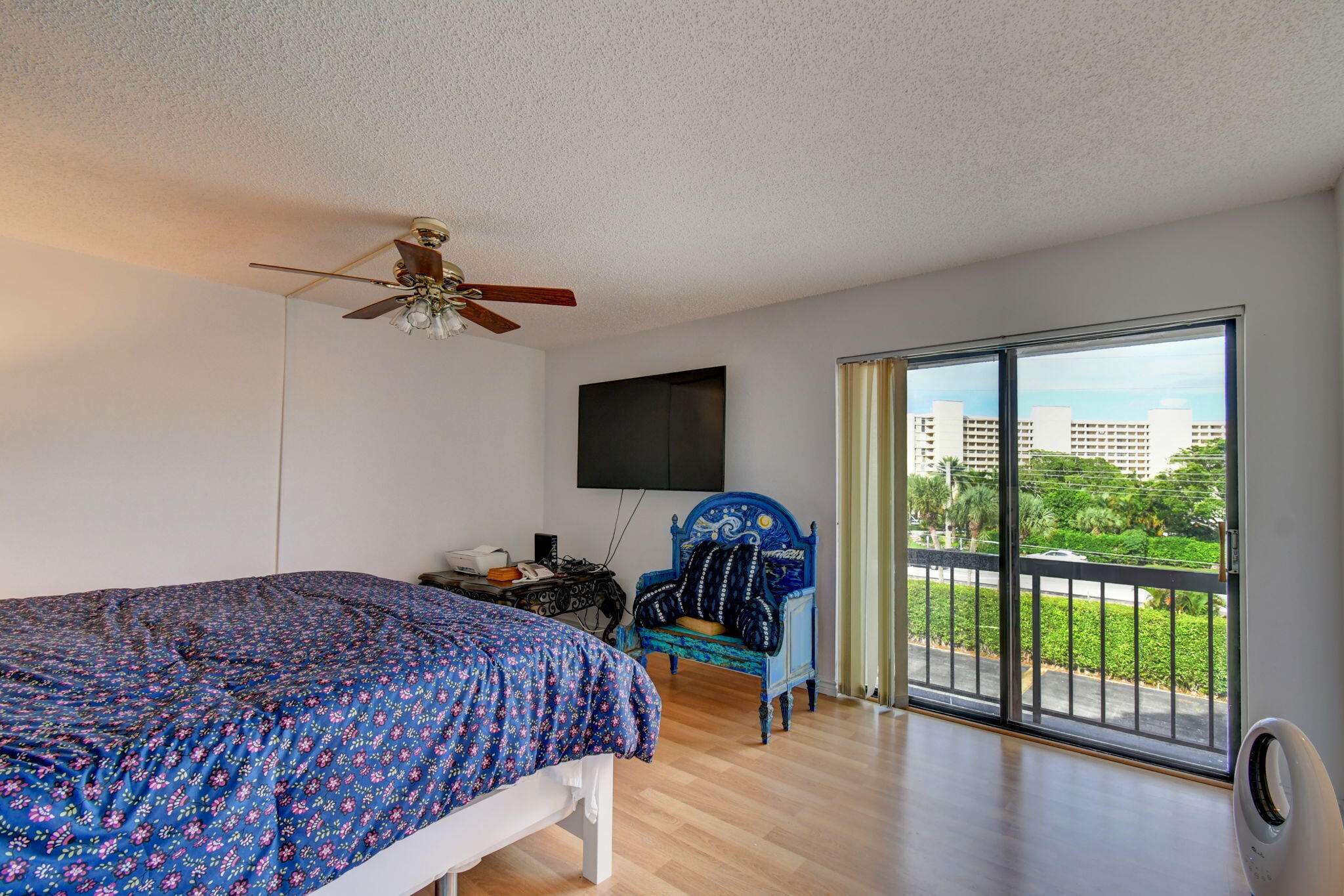 300 Golfview Road, Unit 407 North Palm Beach, FL 33408 - Photo 20 of 56 a bedroom with a bed and glass door