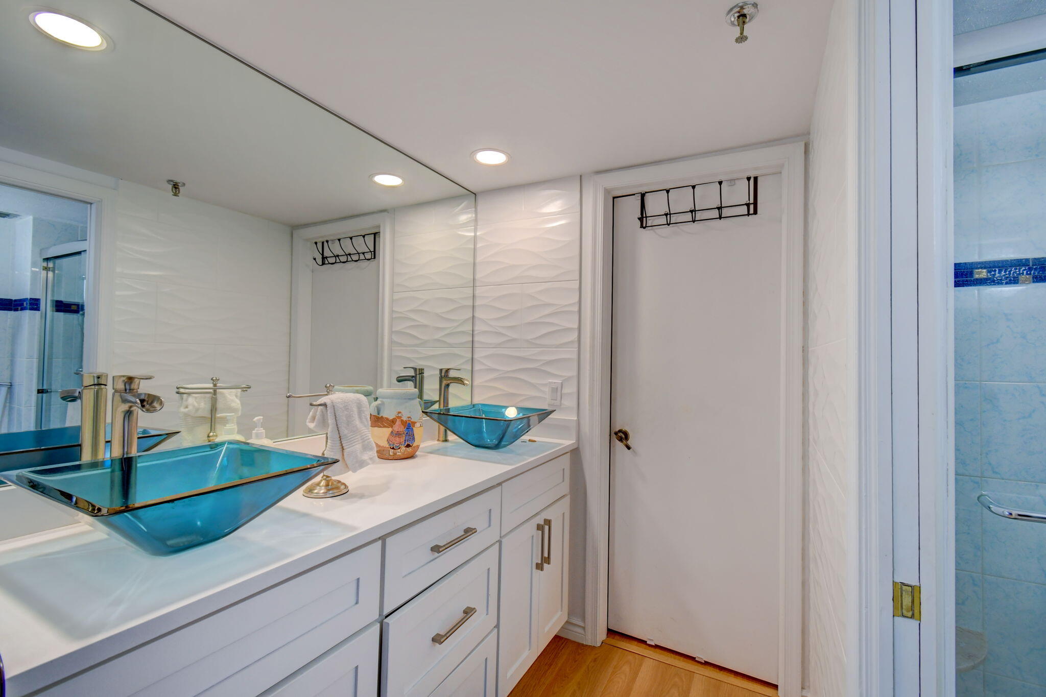 300 Golfview Road, Unit 407 North Palm Beach, FL 33408 - Photo 22 of 56 a bathroom with a sink a mirror and a shower