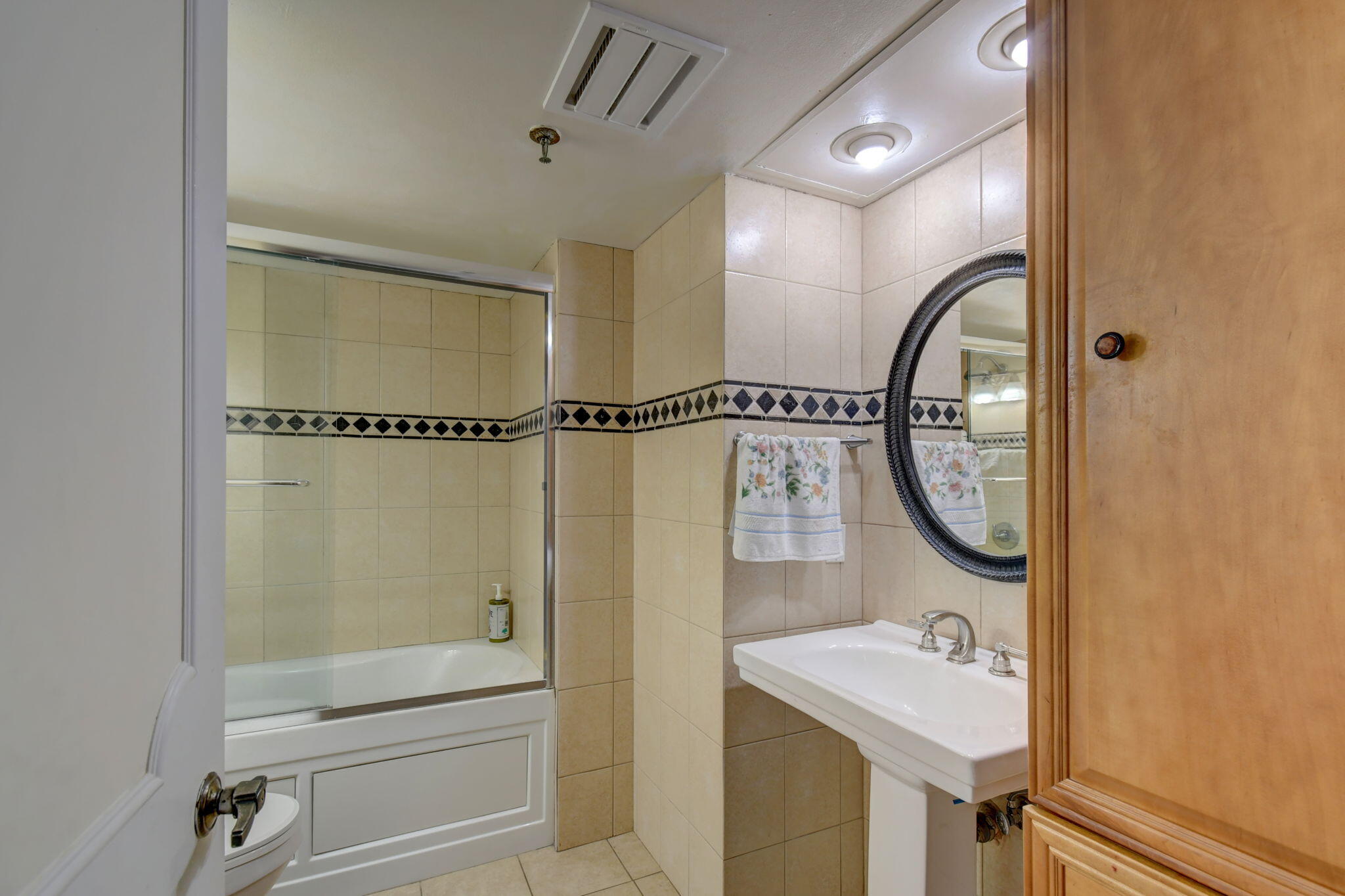 300 Golfview Road, Unit 407 North Palm Beach, FL 33408 - Photo 26 of 56 a bathroom with a sink mirror toilet and shower