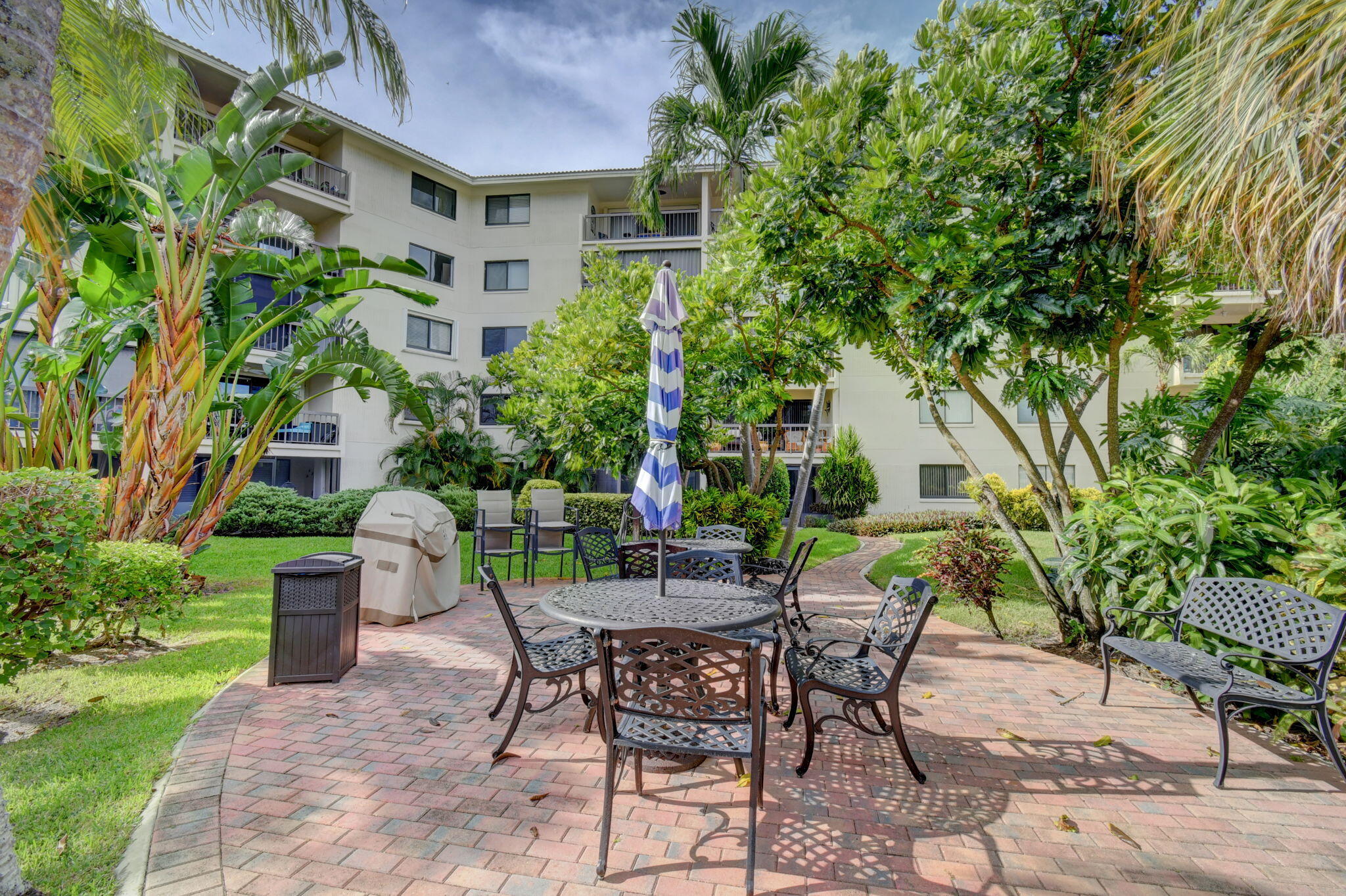 300 Golfview Road, Unit 407 North Palm Beach, FL 33408 - Photo 48 of 56 a patio with table and chairs and potted plants