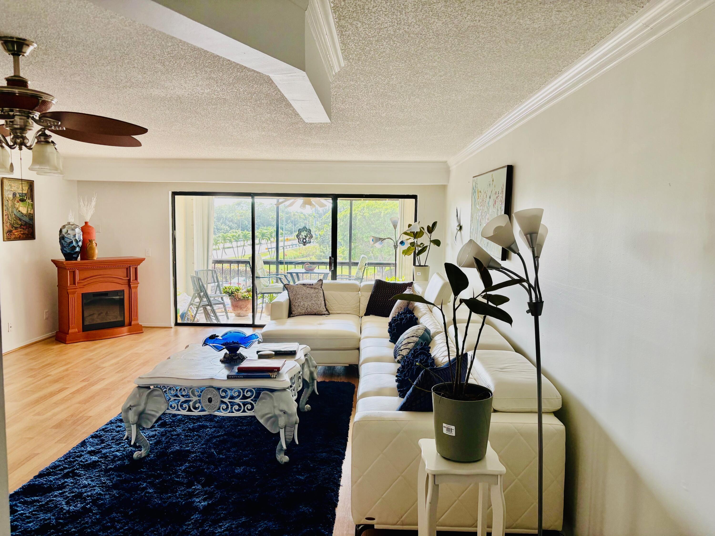 300 Golfview Road, Unit 407 North Palm Beach, FL 33408 - Photo 9 of 56 a living room with furniture and a floor to ceiling window