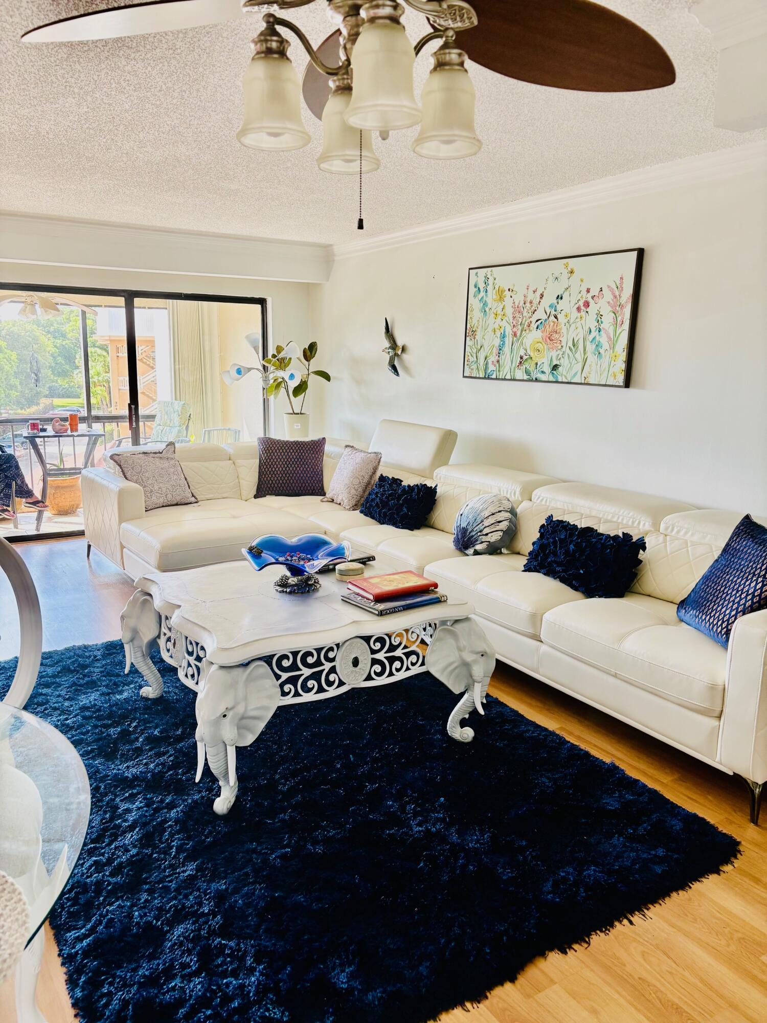 300 Golfview Road, Unit 407 North Palm Beach, FL 33408 - Photo 10 of 56 a living room with furniture rug and window