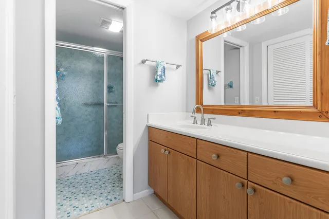 a bathroom with a sink a mirror and shower