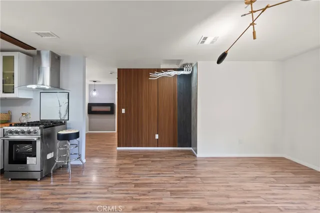 a view of kitchen with stainless steel appliances granite countertop a refrigerator and a stove