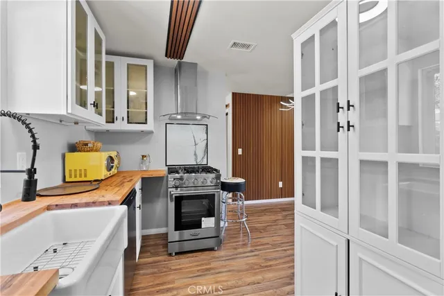 a kitchen with stainless steel appliances granite countertop a stove and a sink