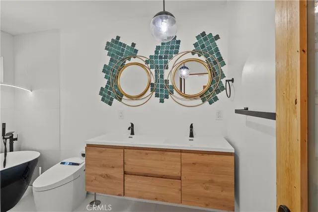 a bathroom with a toilet a sink and a mirror