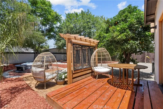 an outdoor sitting area with furniture and garden view